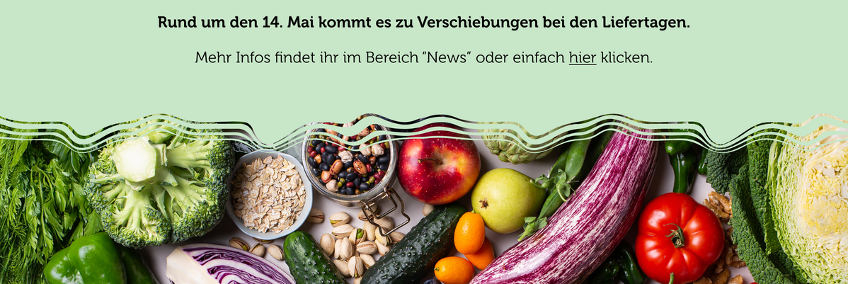 KI generiert: Frisches Gemüse und Obst mit Hinweis auf Lieferverzögerungen um den 14. Mai. Text: „Rund um den 14. Mai kommt es zu Verschiebungen bei den Liefer­tagen. Mehr Infos findet ihr im Bereich 'News' oder einfach hier klicken.“