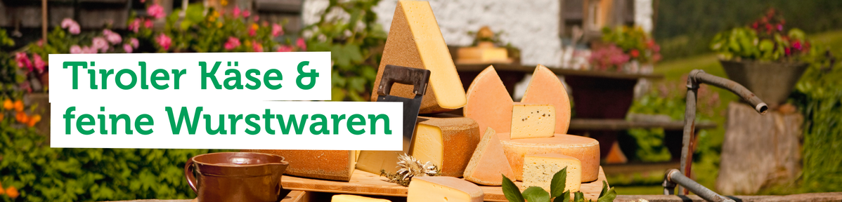 KI generiert: Tiroler Käse und feine Wurstwaren auf hölzernem Brett, umgeben von Blumen.